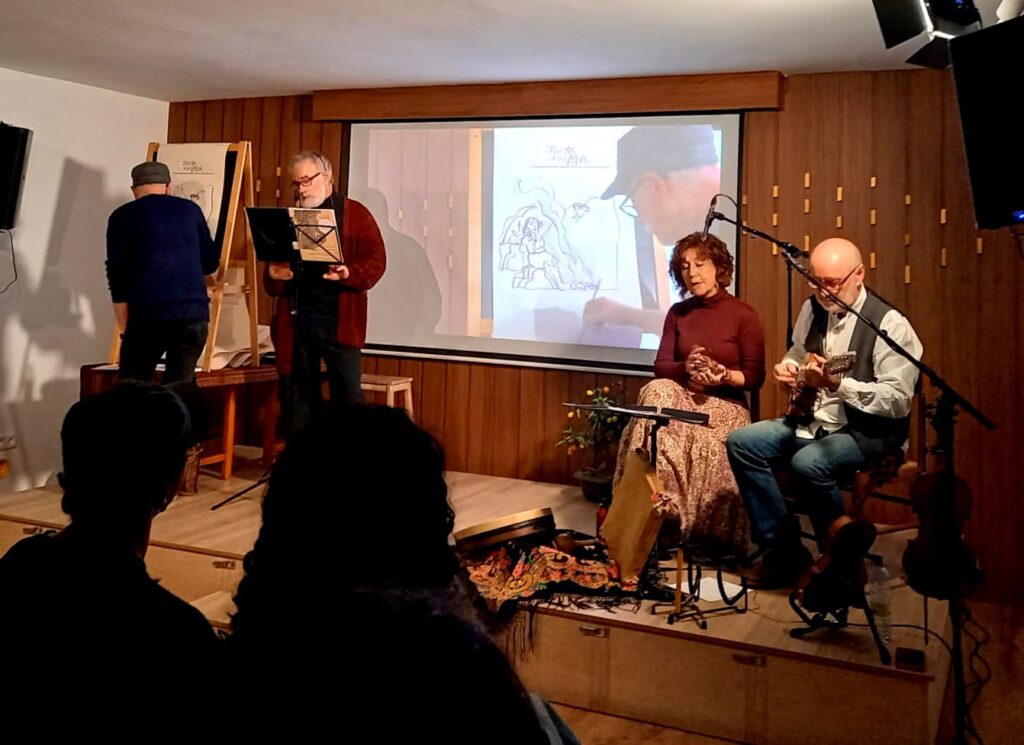 Imagen del concierto solidario "Cuentos de Antiguamente" a favor de la investigación del Síndrome de Wolfram.
En la imagen se ve a Javier Olivares dibujando, a Antonio Perla de narrador, y cantando a Pilar López Ballarín y José Climent.